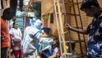 A healthcare worker collects a swab sample from a resident of Dharavi in Mumbai on Friday.(PTI Photo) A healthcare worker collects a swab sample from a resident of Dharavi in Mumbai on Friday.(PTI Photo)