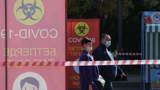 People wear protective face masks as a preventive measure against the spread of the coronavirus disease (COVID-19) at an annual food fair in the city of Almaty, Kazakhstan October 17, 2020. Signs read: "COVID-19. Wear a mask". REUTERS/Pavel Mikheyev/File Photo (REUTERS)