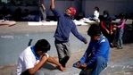 A migrant boy, center, launches a paper airplane while playing with other migrant children at a plaza near the McAllen-Hidalgo International Bridge point of entry into the US, after being caught trying to sneak into the US and deported in Reynosa, Mexico. (AP) A migrant boy, center, launches a paper airplane while playing with other migrant children at a plaza near the McAllen-Hidalgo International Bridge point of entry into the US, after being caught trying to sneak into the US and deported in Reynosa, Mexico. (AP)