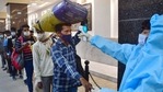 A healthcare worker conducts thermal screening of a passenger at CSMT Railway Station in Mumbai on Wednesday, as Covid-19 cases spike across Maharashtra.(PTI Photo) A healthcare worker conducts thermal screening of a passenger at CSMT Railway Station in Mumbai on Wednesday, as Covid-19 cases spike across Maharashtra.(PTI Photo)