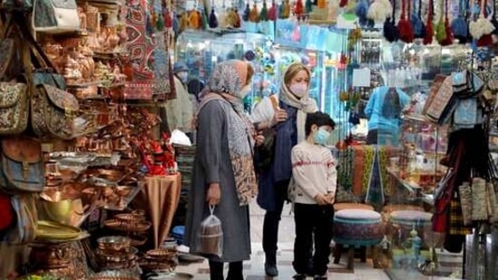 This week, throngs of mask-clad shoppers packed the metro and jockeyed to buy last-minute gifts and sweets at Tehran's storied Grand Bazaar (AP Photo/Ebrahim Noroozi)(AP) This week, throngs of mask-clad shoppers packed the metro and jockeyed to buy last-minute gifts and sweets at Tehran's storied Grand Bazaar (AP Photo/Ebrahim Noroozi)(AP)