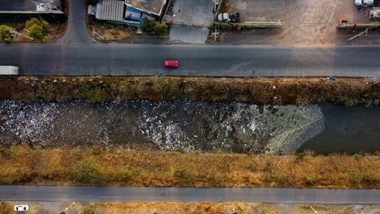 An aerial view shows cars moving next to the Interceptor Poniente canal in Cuautitlan, State of Mexico, Mexico, on March 18. Drainage system waterways around densely-populated Mexico City, like the Interceptor Poniente, are heavily polluted with sewage and trash from nearby communities.(Carlos Jasso / REUTERS)