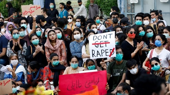 People carry signs against a gang rape that occurred along a highway and to condemn violence against women and girls.(REUTERS)