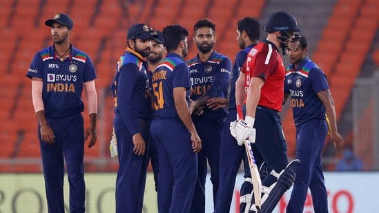 England's Jonny Bairstow walks as India players celebrate his wicket  (REUTERS)