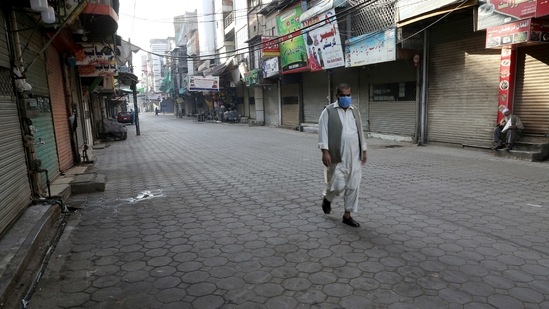 A lone man walks past shops closed in Peshawar, Pakistan on Saturday. (AP Photo ) A lone man walks past shops closed in Peshawar, Pakistan on Saturday. (AP Photo )