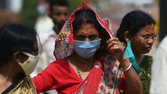 A woman wearing mask as a precaution against the COVID-19 coronavirus stands in a crowded area near India Gate, in New Delhi. (AFP) A woman wearing mask as a precaution against the COVID-19 coronavirus stands in a crowded area near India Gate, in New Delhi. (AFP)
