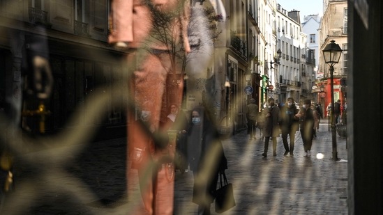 People walk near closed shops in Paris. (AFP)