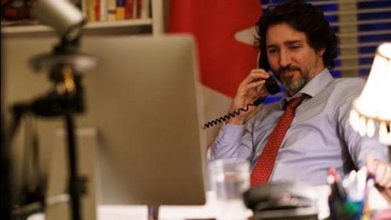 FILE PHOTO: Canada's Prime Minister Justin Trudeau speaks on the phone with U.S. President Joe Biden, who made the first call to a foreign leader following his inauguration, in Ottawa, Ontario, Canada January 22, 2021. Picture taken January 22, 2021. Adam Scotti/Prime Minister's Office/Handout via REUTERS THIS IMAGE HAS BEEN SUPPLIED BY A THIRD PARTY./File Photo (via REUTERS)