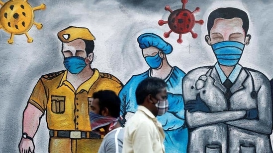 Men walk past a mural of frontline workers amid the spread of the coronavirus disease in Mumbai, India. (REUTERS) Men walk past a mural of frontline workers amid the spread of the coronavirus disease in Mumbai, India. (REUTERS)