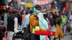 An Indian vendor wearing face mask as a precaution against the coronavirus sells curios at Sunday market in Jammu, India.(AP) An Indian vendor wearing face mask as a precaution against the coronavirus sells curios at Sunday market in Jammu, India.(AP)