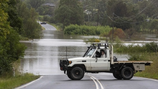 Vehicles are blocked by a flooded river at Old Pitt Town north-west of Sydney on March 21. People in parts of Sydney's northwest were ordered to flee their houses in the middle of the night as fast-moving waters caused widespread destruction.(Mark Baker / AP)