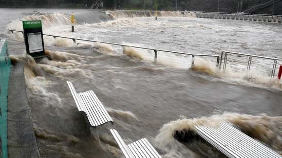 The swollen Parramatta River is seen overflowing during heavy rains in Sydney on March 20. The flooding comes in stark contrast with the devastating bushfires that struck Australia in late 2019 and early 2020, when nearly 7% of New South Wales land was scorched.(Dan Himbrechts via REUTERS)