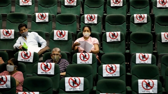 People sit under observation after receiving a dose of Covid-19 vaccine, at an auditorium which has been converted into a temporary vaccination centre in Ahmedabad, on March 16. A total of 11,130,288 people have recovered from the viral contagion, with 22,956 recoveries reported on March 21, lodging the country's recovery rate at 95.9%, HT reported.(Amit Dave / REUTERS)