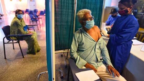 An elderly man gets vaccinated against Covid-19, at Kukreja Hospital, Bali Nagar, in New Delhi, on March 19. The sharp rise in Covid-19 cases has been recorded in March, which experts point out is an evident second wave based on the increasing positivity rate and active cases.(Sanchit Khanna / HT Photo)