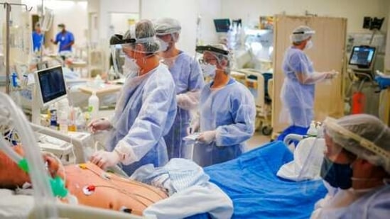 Health workers tend to a Covid-19 patient in the ICU ward at the Hospital das Clinicas in Porto Alegre, Brazil. (AP) Health workers tend to a Covid-19 patient in the ICU ward at the Hospital das Clinicas in Porto Alegre, Brazil. (AP)