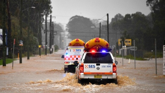State Emergency Service vehicles approach flooded residential areas in western Sydney amid mass evacuations being ordered in low-lying areas along Australia's east coast as torrential rains caused potentially "life-threatening" floods. (AFP)