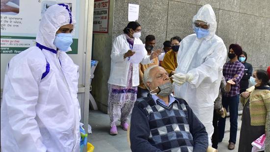 File photo: A health worker (R) collects a nasal swab sample from a man to test for Covid-19. (Sameer Sehgal/Hindustan Times)