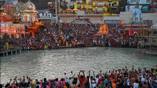 (File photo: Devotees attend evening prayers after taking a holy dip in the waters of the River Ganges on the Shahi Snan. (AFP)