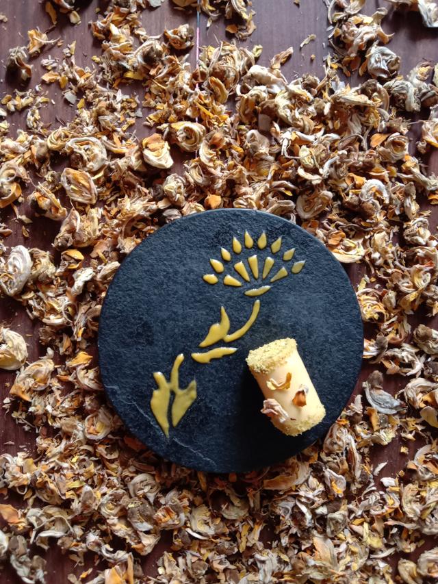 Tesu Ki Barfi, is made from natural spring flower and tinted milk cannelloni stuffed with tesu coloured rabri, topped with palm sugar coated tesu flowers. Tesu Ki Barfi, is made from natural spring flower and tinted milk cannelloni stuffed with tesu coloured rabri, topped with palm sugar coated tesu flowers.