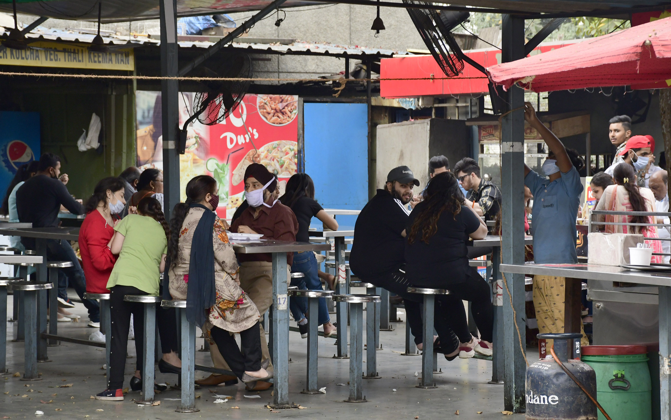 Residents enjoying their meal at an eatery in Ghumar Mandi, Ludhiana, on Sunday even though only takeaways and home delivery services are allowed. (Harsimar Pal Singh/HT) Residents enjoying their meal at an eatery in Ghumar Mandi, Ludhiana, on Sunday even though only takeaways and home delivery services are allowed. (Harsimar Pal Singh/HT)