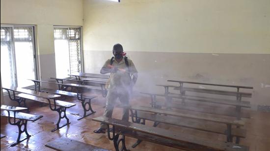 Bengaluru: An MCD worker sprays disinfectant inside a classroom at Maharani College of Arts and Science. (PTI) Bengaluru: An MCD worker sprays disinfectant inside a classroom at Maharani College of Arts and Science. (PTI)