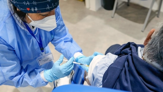 A health worker administers the Moderna Inc. Covid-19 vaccine to a visitor at a Covid-19 vaccination center in Rome, Italy, (Bloomberg) A health worker administers the Moderna Inc. Covid-19 vaccine to a visitor at a Covid-19 vaccination center in Rome, Italy, (Bloomberg)