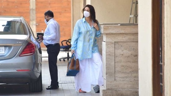 The mother-of-two was even spotted wearing a baggy light blue shirt which was adorned with golden print and she teamed it with a pair of white wide-legged pants.(Varinder Chawla)