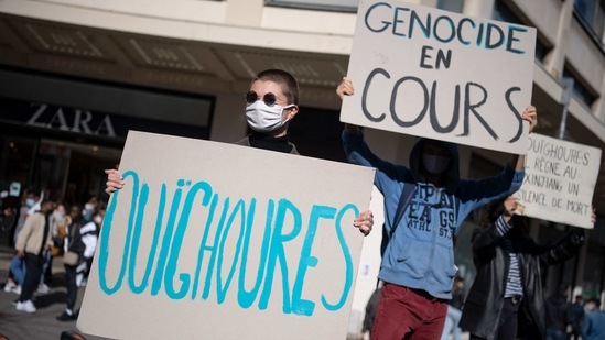 Protesters hold banners to support Uyghurs minorities in Nantes, western France, on March 19.(AFP Photo)