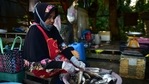 A vendor prepares freshwater fish at a roadside market in southern Thailand's Narathiwat province.(AFP) A vendor prepares freshwater fish at a roadside market in southern Thailand's Narathiwat province.(AFP)