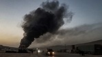 This picture taken on March 21, 2021, shows a view of a billowing smoke plume coming from burning trucks and freight vehicles in the aftermath of airstrikes at a depot near the Bab al-Hawa border crossing between Syria and Turkey in Syria's rebel-held northwestern Idlib province. (AFP) This picture taken on March 21, 2021, shows a view of a billowing smoke plume coming from burning trucks and freight vehicles in the aftermath of airstrikes at a depot near the Bab al-Hawa border crossing between Syria and Turkey in Syria's rebel-held northwestern Idlib province. (AFP)