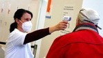 Medical staff takes the temperature of an elderly man arriving at a local vaccination centre as the spread of the coronavirus disease (Covid-19) continues in Ebersberg near Munich, Germany.(AP) Medical staff takes the temperature of an elderly man arriving at a local vaccination centre as the spread of the coronavirus disease (Covid-19) continues in Ebersberg near Munich, Germany.(AP)