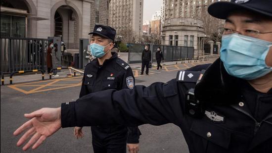 Police officers ask journalists to move away from outside the Beijing Second Intermediate People's Court on March 22, 2021, during the trial of Michael Kovrig, a Canadian detained more than two years ago in China on espionage charges. (AFP) Police officers ask journalists to move away from outside the Beijing Second Intermediate People's Court on March 22, 2021, during the trial of Michael Kovrig, a Canadian detained more than two years ago in China on espionage charges. (AFP)