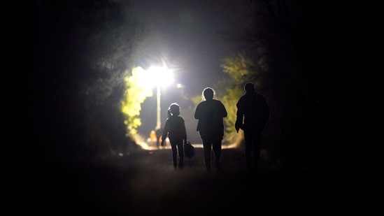 A 7-year-old migrant girl from Honduras, left, walks with Fernanda Solis, 25, centre, also of Honduras. (AP) A 7-year-old migrant girl from Honduras, left, walks with Fernanda Solis, 25, centre, also of Honduras. (AP)