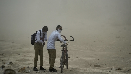Students walk during a heavy dust storm at the Delhi-Ghazipur border, in New Delhi on Monday. (ANI Photo)