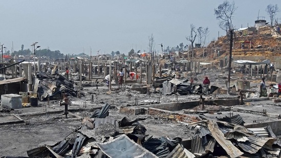 People are seen amidst the debris at a Rohingya refugee camp in Ukhia on March 23 after the blaze forced thousands to flee. Fifteen people have so far been confirmed dead and 400 are still missing, the United Nations said March 23.(AFP)
