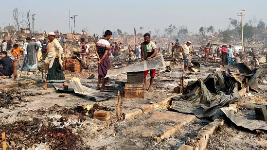 Rohingya refugees sift through rubble at the site where their shelters burned down in Cox's Bazar on March 23. "What we have seen in this fire is something we have never seen before in these camps. It is massive. It is devastating," Johannes van der Klaauw, the UN Refugee Agency's representative in Bangladesh, told reporters in Geneva via video-link from Dhaka.(Ro Yassin Abdumonab / REUTERS)