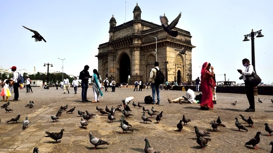 The bustle of the Gateway back, in this scene a year later on March 20. Precautions, now internalised, persist despite major relaxations from the hard lockdown that came last year.(Anshuman Poyrekar / HT Photo)