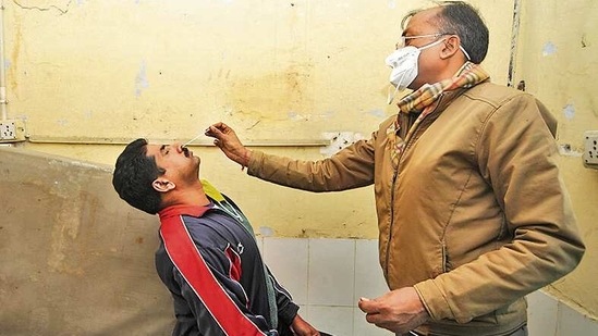 A health worker collects a swab sample to test for Covid-19 at a health centre in Greater Noida. (Sunil Ghosh /HT) A health worker collects a swab sample to test for Covid-19 at a health centre in Greater Noida. (Sunil Ghosh /HT)