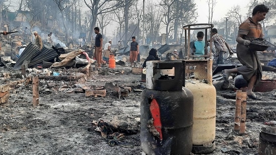 People are seen clearing debris at a Rohingya refugee camp in Ukhia on March 23, the day after a huge blaze. The UN's International Organization for Migration (IOM) said it has pledged $1 million to relief efforts but a further $20 million would be required to react to the most urgent needs.(AFP)