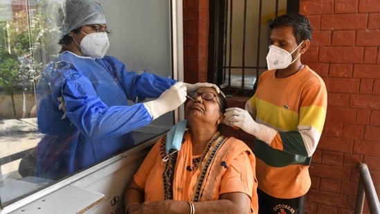 A health worker collects a nasal swab sample from a woman to test for the Covid-19 coronavirus at the Civil hospital in Amritsar on March 19, 2021. (AFP) A health worker collects a nasal swab sample from a woman to test for the Covid-19 coronavirus at the Civil hospital in Amritsar on March 19, 2021. (AFP)