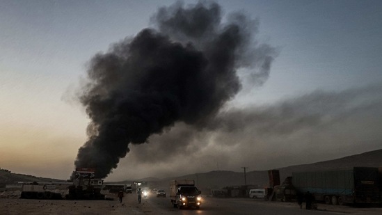 This picture taken on March 21, 2021, shows a view of a billowing smoke plume coming from burning trucks and freight vehicles in the aftermath of airstrikes at a depot near the Bab al-Hawa border crossing between Syria and Turkey in Syria's rebel-held northwestern Idlib province. (AFP) This picture taken on March 21, 2021, shows a view of a billowing smoke plume coming from burning trucks and freight vehicles in the aftermath of airstrikes at a depot near the Bab al-Hawa border crossing between Syria and Turkey in Syria's rebel-held northwestern Idlib province. (AFP)