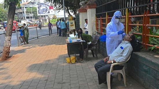 A health worker collecting samples for Covid-19 testing in Mumbai. (AFP) A health worker collecting samples for Covid-19 testing in Mumbai. (AFP)