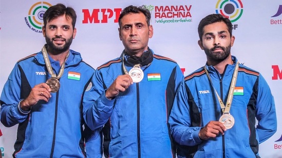 (L-R) Gurjoat Khangura, Mairaj Ahmad Khan, Angad Vir Singh Bajwa show their Gold medal after winning the Men's Skeet Team competition during ISSF Shooting World Cup 2021 (PTI) (L-R) Gurjoat Khangura, Mairaj Ahmad Khan, Angad Vir Singh Bajwa show their Gold medal after winning the Men's Skeet Team competition during ISSF Shooting World Cup 2021 (PTI)