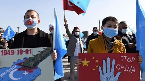 Members of the Uyghur community living in Turkey, hold banners as the join a protest against China, in Istanbul, Friday, Feb. 26, 2021. More than a million Uyghurs and other largely Muslim minorities have been swept into prisons and detention camps in China, in what China calls an anti-terrorism measure. Uyghurs, a Turkic group native to China's far west Xinjiang region, have sought refuge in Turkey for decades because of their shared cultural ties with the country. (AP Photo/Omer Kuscu) (AP) Members of the Uyghur community living in Turkey, hold banners as the join a protest against China, in Istanbul, Friday, Feb. 26, 2021. More than a million Uyghurs and other largely Muslim minorities have been swept into prisons and detention camps in China, in what China calls an anti-terrorism measure. Uyghurs, a Turkic group native to China's far west Xinjiang region, have sought refuge in Turkey for decades because of their shared cultural ties with the country. (AP Photo/Omer Kuscu) (AP)