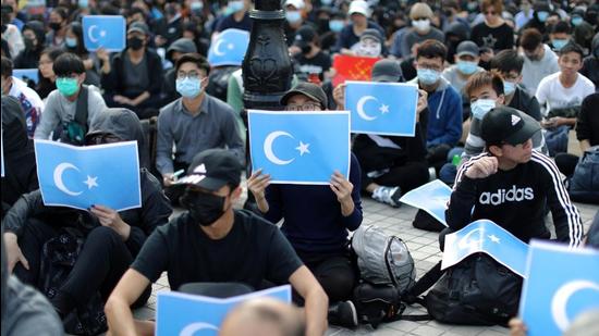 Hong Kong protesters hold East Turkestan Uighur flags at a rally in support of the Uighurs' human rights, in Hong Kong on December 22, 2019. (REUTERS/File) Hong Kong protesters hold East Turkestan Uighur flags at a rally in support of the Uighurs' human rights, in Hong Kong on December 22, 2019. (REUTERS/File)