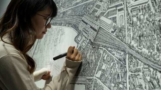 Chinese artist Yang Qian using dots to recreate an aerial view of Wuhan, China, under lockdown at her studio in Wuhan in central China's Hubei province on Sunday, Jan. 24, 2021. (AP)