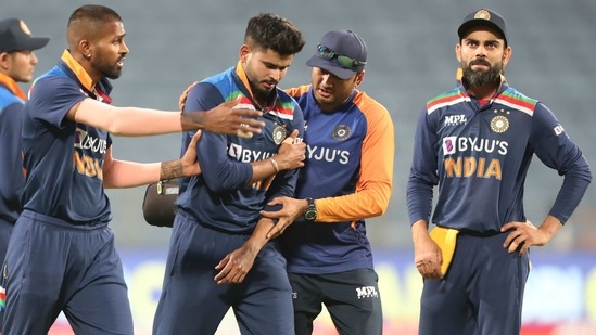 India's Shreyas Iyer, center, walks off the field after injuring himself.(AP)