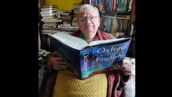 Ruskin Bond sitting with his favourite book. (Facebook/Ruskin Bond)