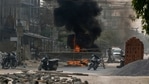 Armed Myanmar riot policemen and soldiers reach a makeshift barricade made by anti-coup protesters in Mandalay, Myanmar, Tuesday, March 23, 2021. (AP) Armed Myanmar riot policemen and soldiers reach a makeshift barricade made by anti-coup protesters in Mandalay, Myanmar, Tuesday, March 23, 2021. (AP)