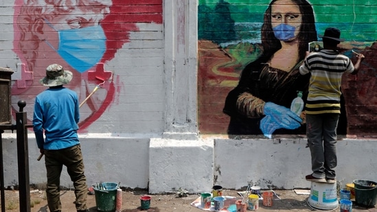 Artists make murals of characters wearing masks to spread awareness for the prevention of Covid-19 in Mumbai. (AP) Artists make murals of characters wearing masks to spread awareness for the prevention of Covid-19 in Mumbai. (AP)